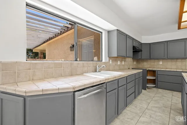 a kitchen with a sink and cabinets