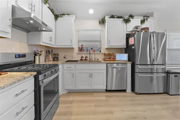 a kitchen with appliances cabinets and a sink