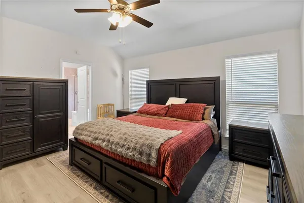 a bedroom with a bed and ceiling fan
