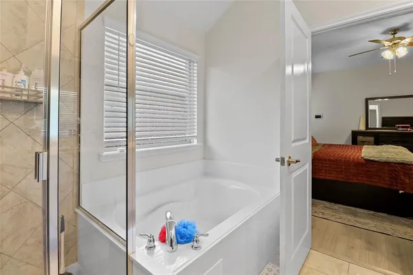 a bathroom with a tub and a shower