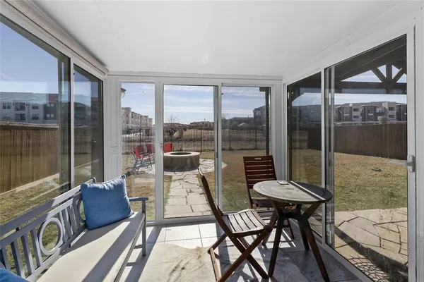 a living room with furniture and a floor to ceiling window