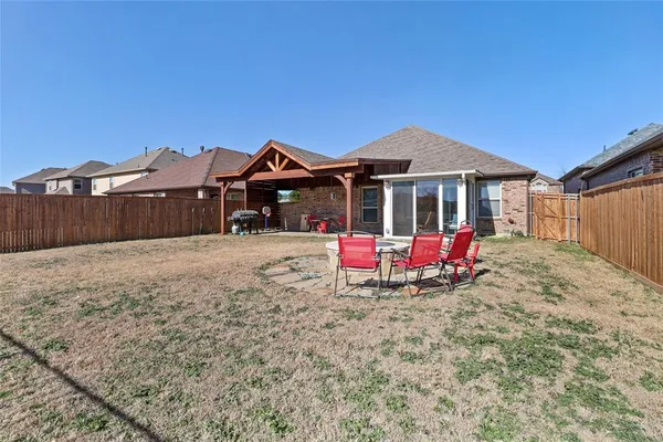 a view of a house with a yard and roof