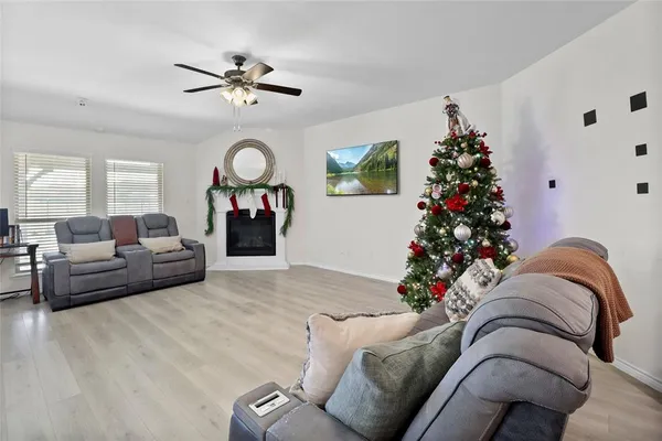 a living room with furniture potted plant and a chandelier