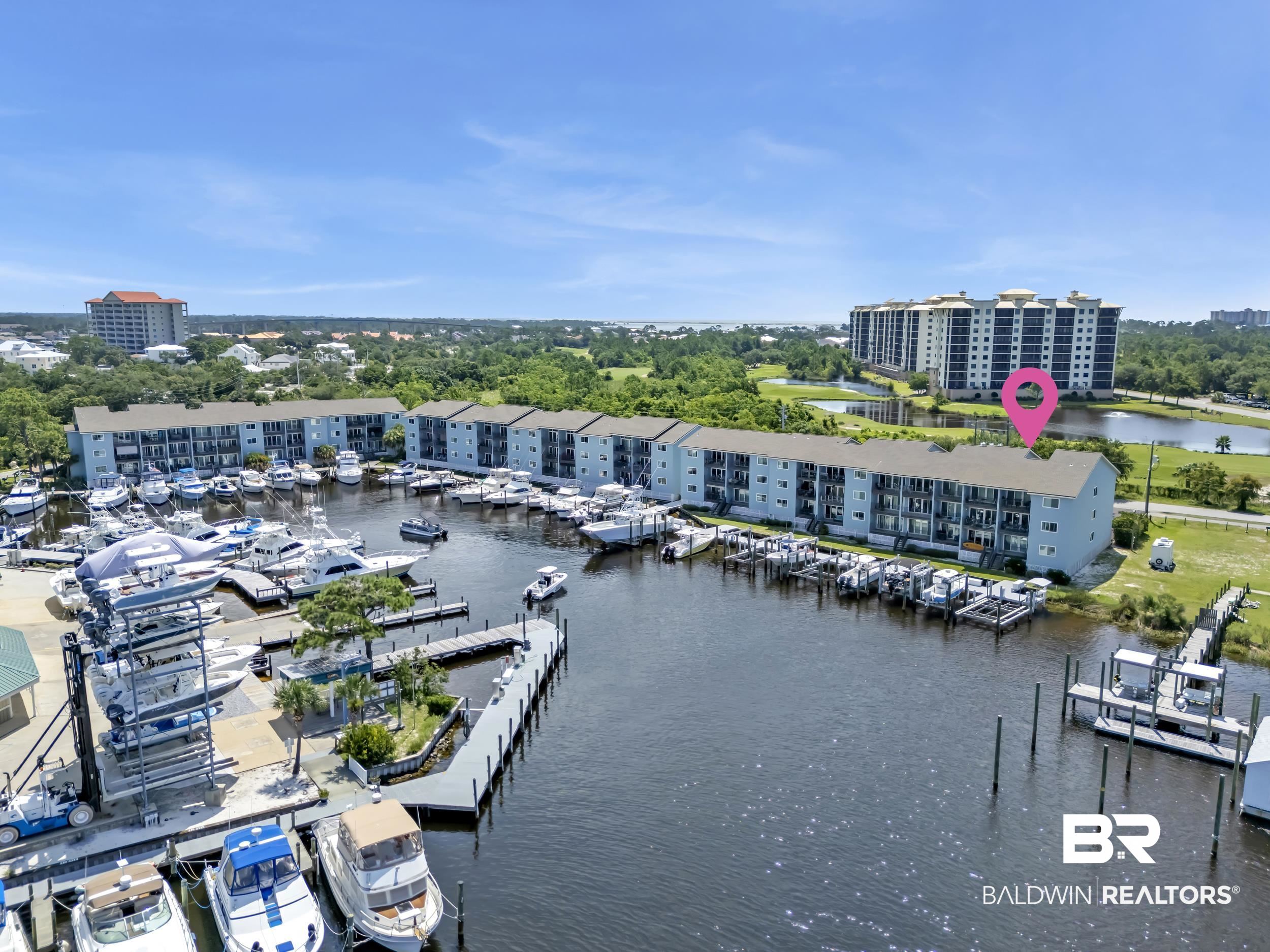 14100 River Road, Unit 211 Pensacola, FL 32507 - Photo 39 of 56 Waterfront multi-story building featuring private boat slips, balconies, and a marina setting