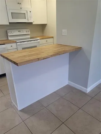a kitchen with granite countertop a sink and a stove