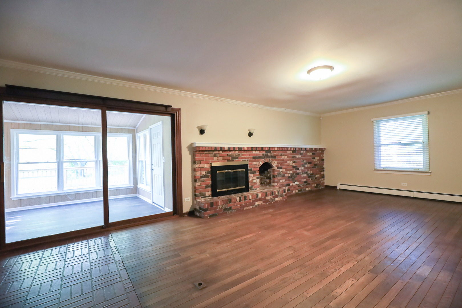 248 Florence Road Inverness, IL 60010 - Photo 9 of 25 an empty room with wooden floor fireplace and windows
