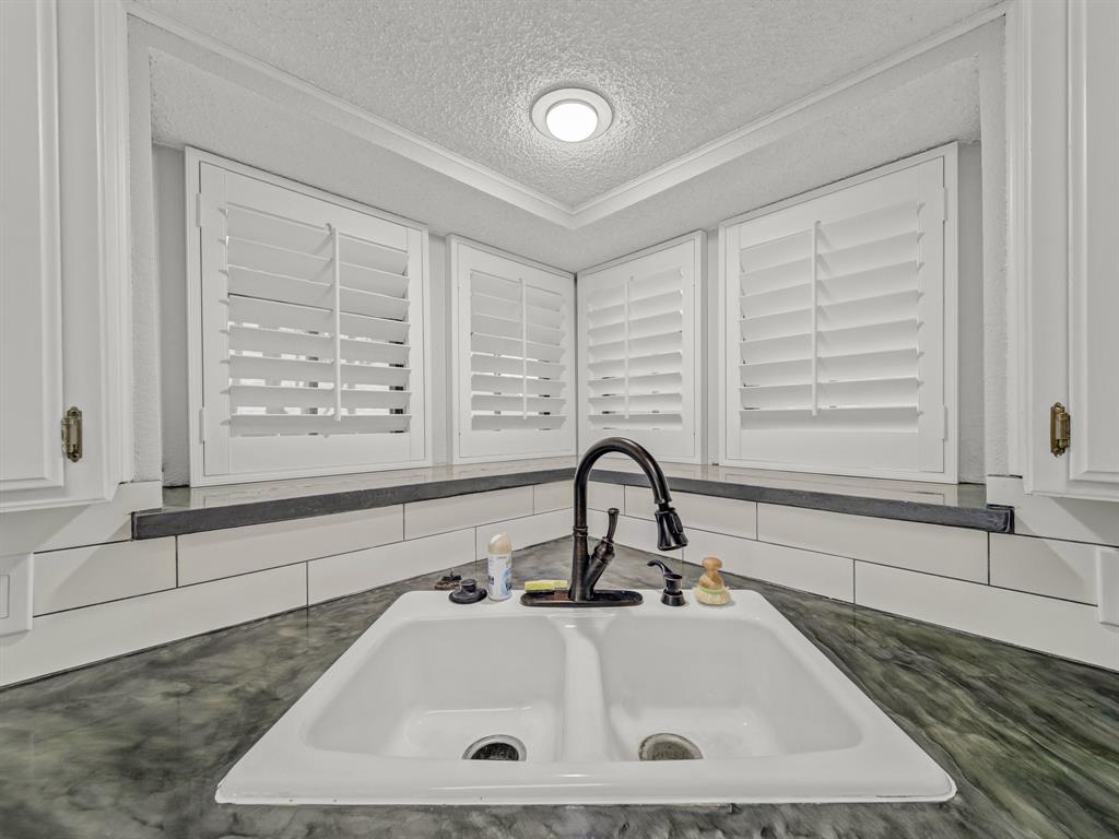 121 Northeast Brushy Mound Road Burleson, TX 76028 - Photo 10 of 35 a bathroom with a sink and a bathtub