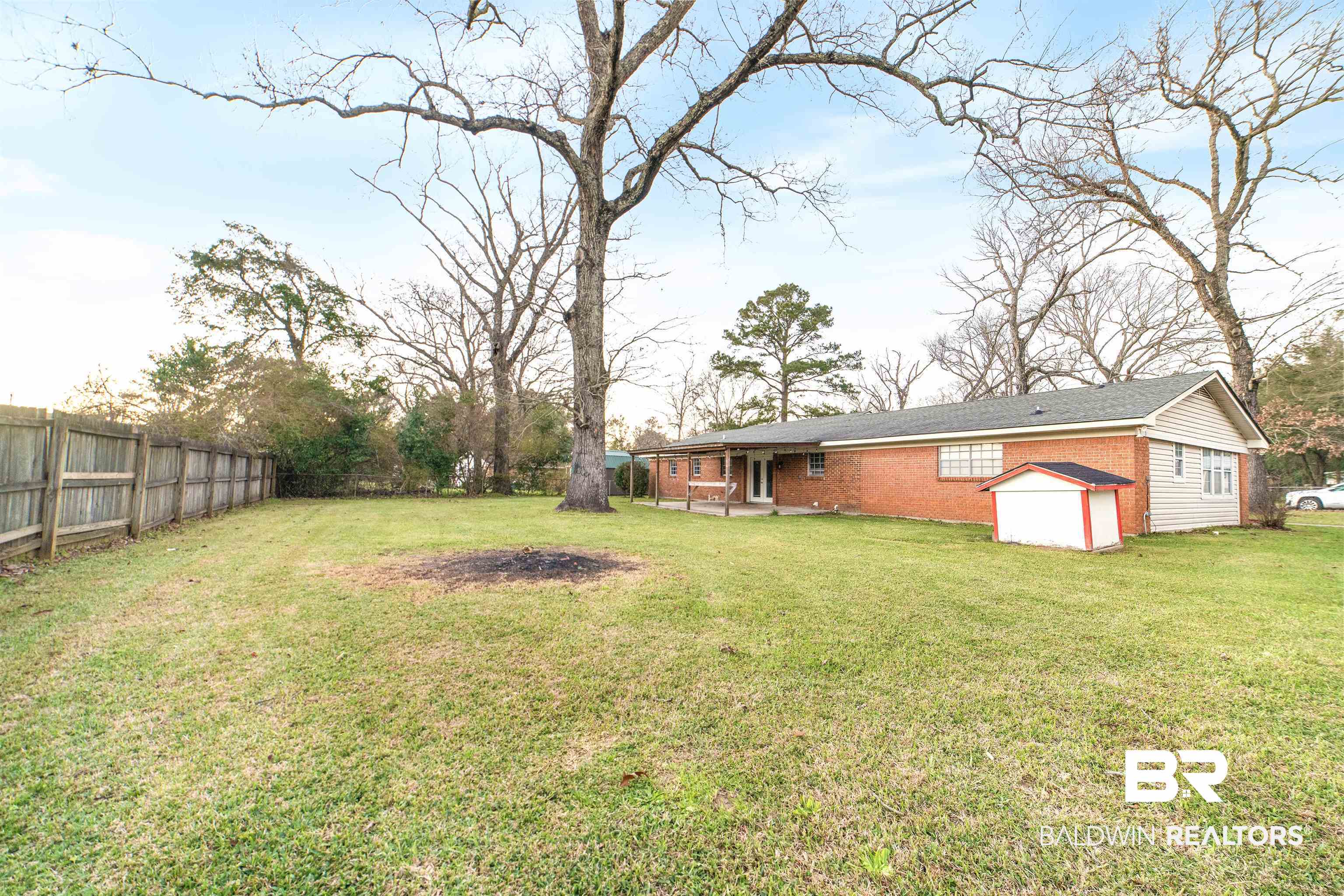 11833 Old Moffat Road Wilmer, AL 36587 - Photo 22 of 23 View of yard featuring an outbuilding, a patio area, a fenced backyard, and a storage unit