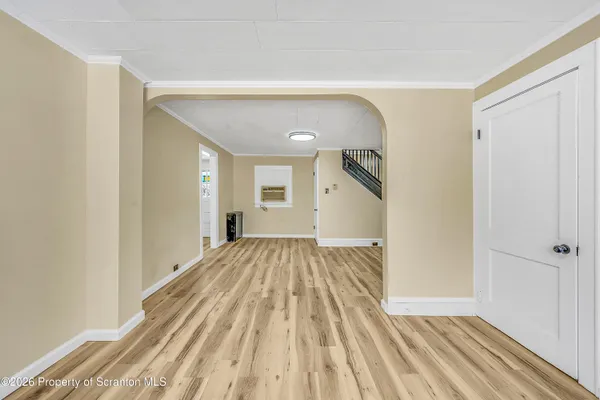 a view of a room with wooden floor and staircase