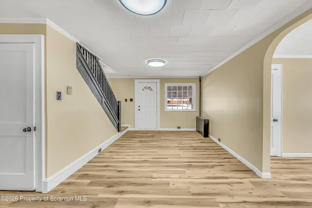 a view of a bedroom with wooden floor and stairs
