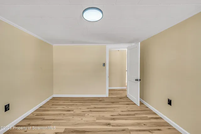 a view of a room with wooden floor and bathroom