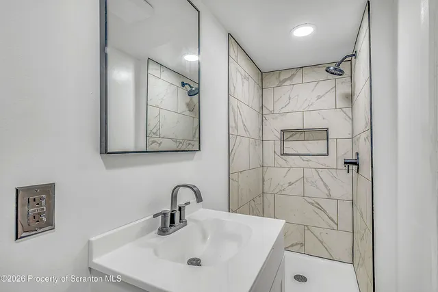 a bathroom with a sink and mirror