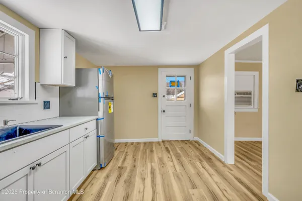 a kitchen with a sink and refrigerator