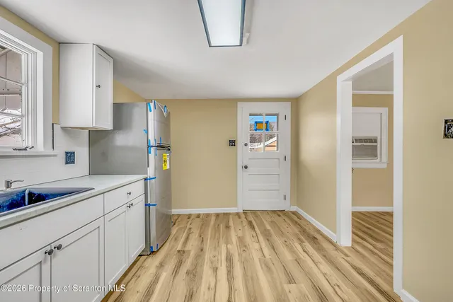 a kitchen with a sink and refrigerator