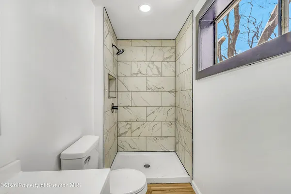 a bathroom with a toilet and shower