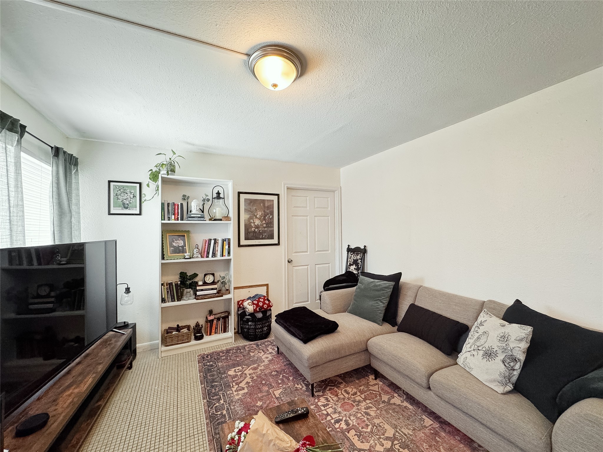 2712 Oakcliff Street Houston, TX 77023 - Photo 11 of 30 a living room with furniture and a flat screen tv