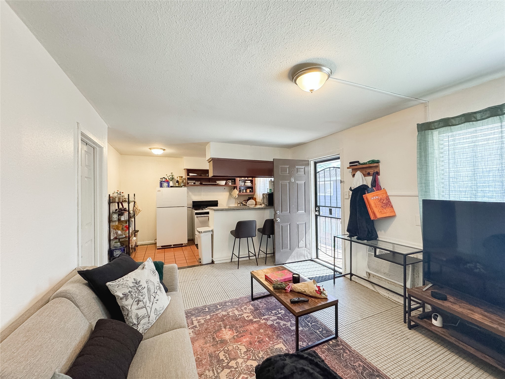 2712 Oakcliff Street Houston, TX 77023 - Photo 13 of 30 a living room with furniture gym equipment and a fireplace