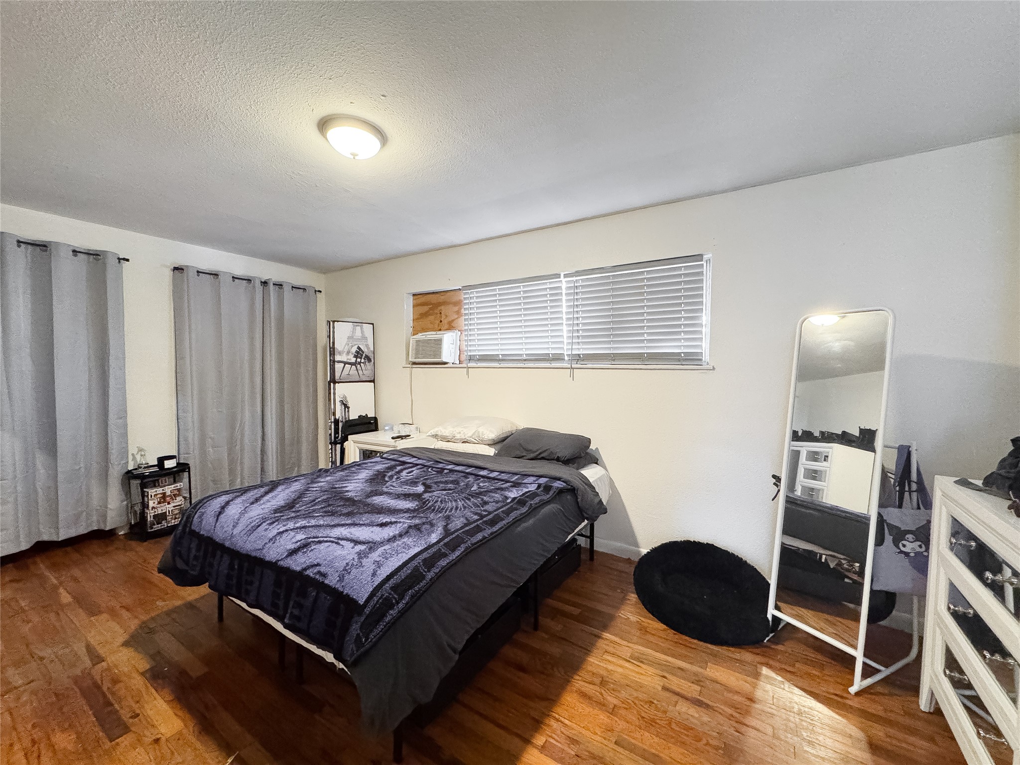 2712 Oakcliff Street Houston, TX 77023 - Photo 14 of 30 a bed sitting in a room next to a window and a chair