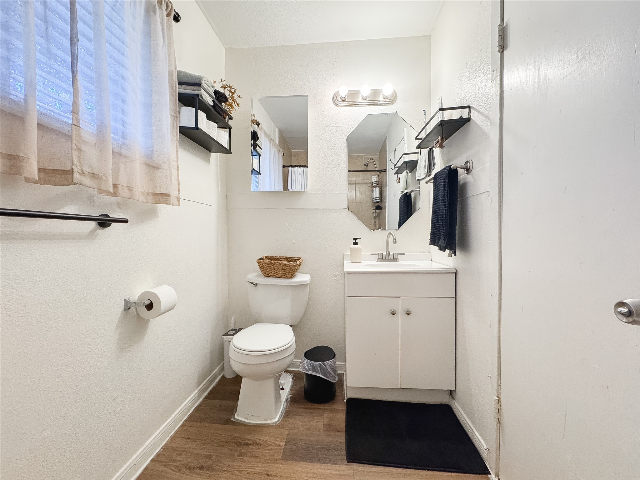 2712 Oakcliff Street Houston, TX 77023 - Photo 17 of 30 a bathroom with a sink toilet a mirror and vanity