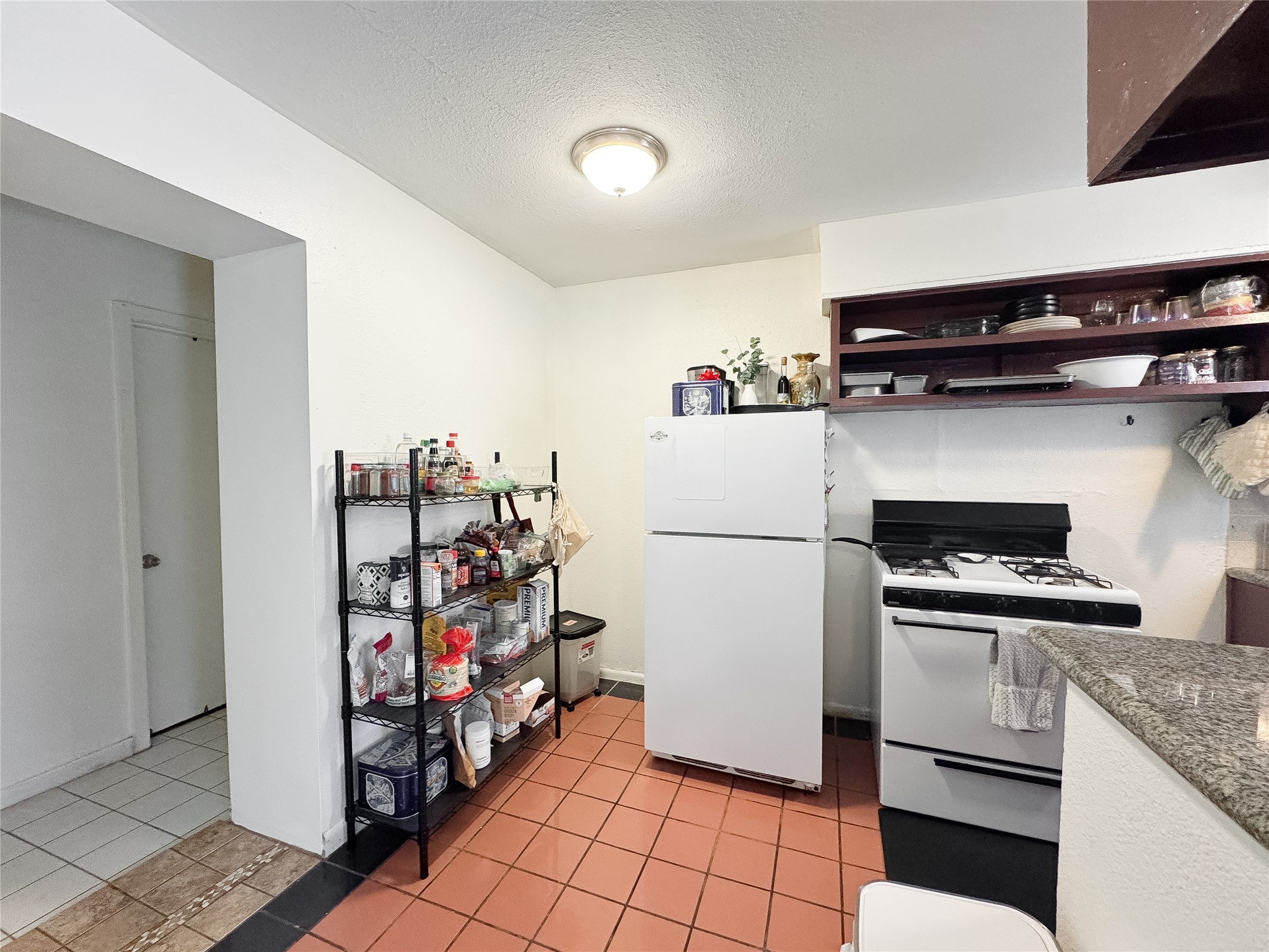 2712 Oakcliff Street Houston, TX 77023 - Photo 19 of 30 a kitchen with stainless steel appliances a refrigerator and a stove top oven