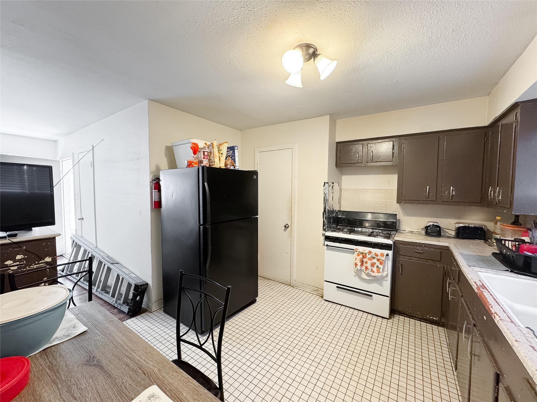 2712 Oakcliff Street Houston, TX 77023 - Photo 22 of 30 a kitchen with granite countertop a refrigerator stove and sink
