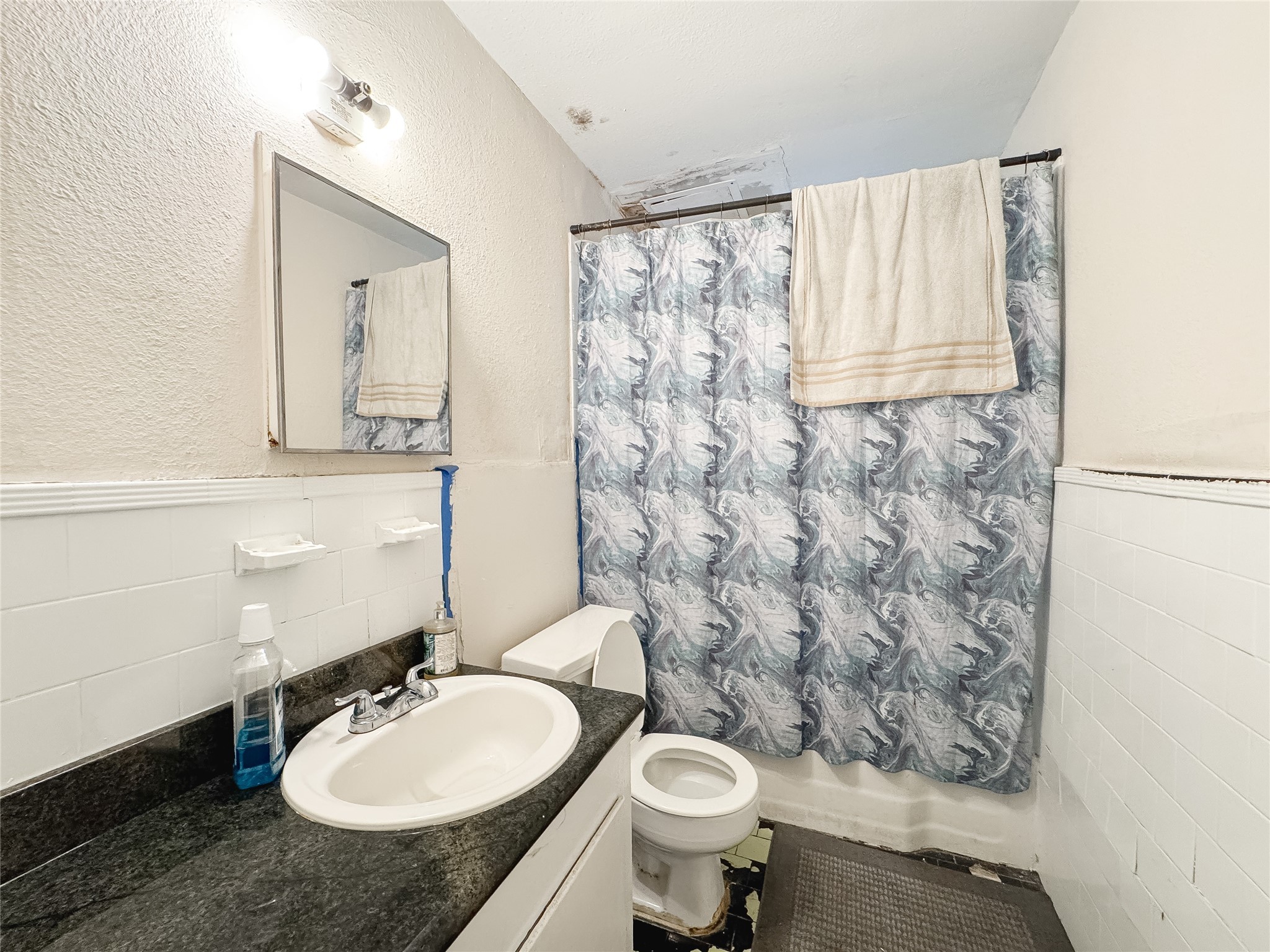 2712 Oakcliff Street Houston, TX 77023 - Photo 23 of 30 a bathroom with a sink toilet a mirror and shower