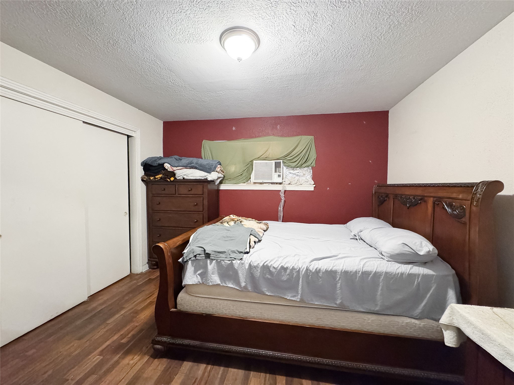 2712 Oakcliff Street Houston, TX 77023 - Photo 24 of 30 a bedroom with a bed and wooden floor