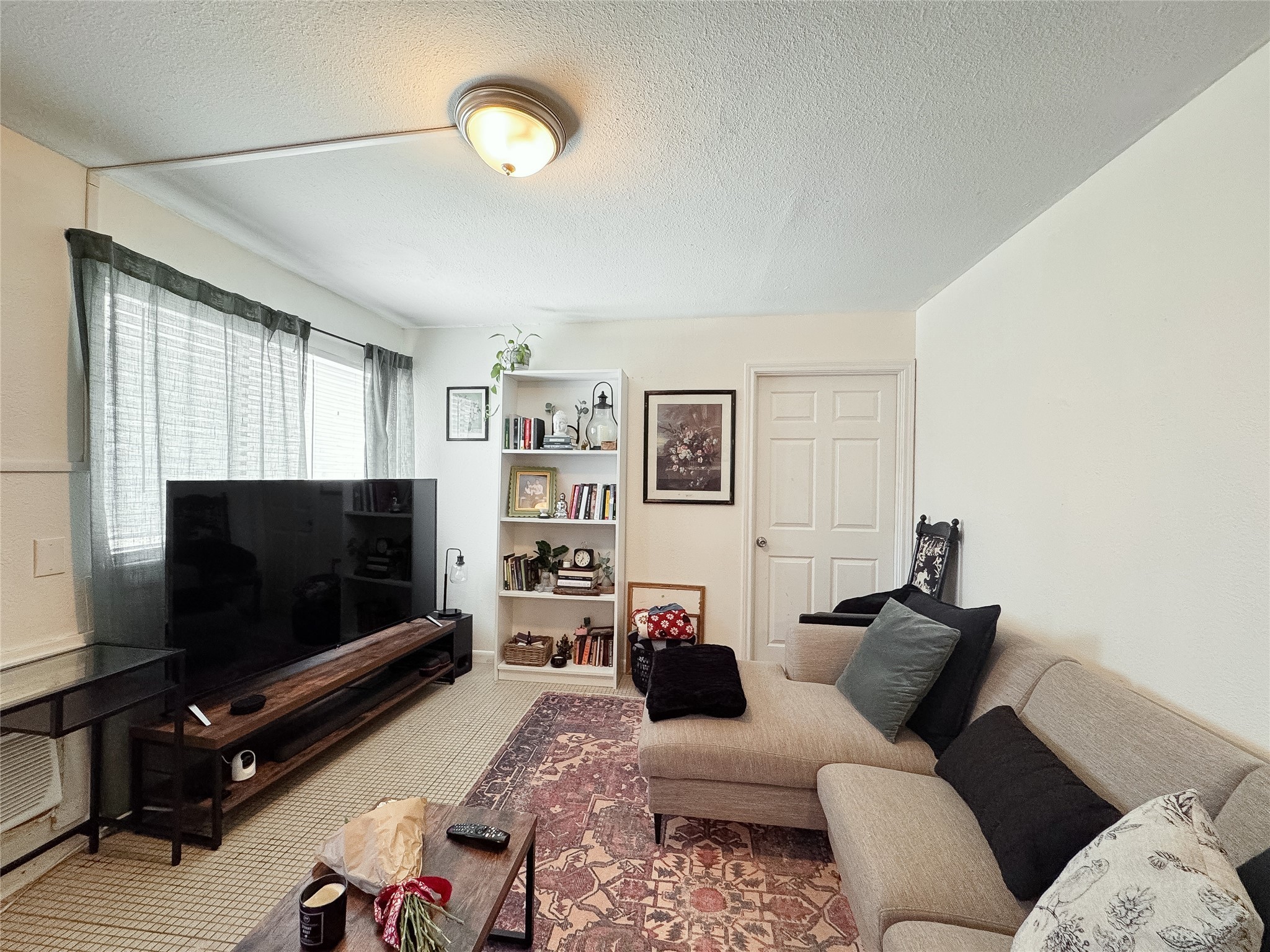 2712 Oakcliff Street Houston, TX 77023 - Photo 10 of 30 a living room with furniture and a flat screen tv
