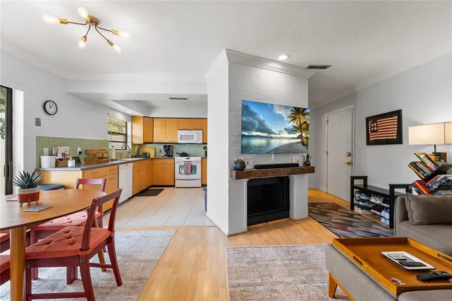 a open kitchen with stainless steel appliances kitchen island granite countertop a stove and a refrigerator