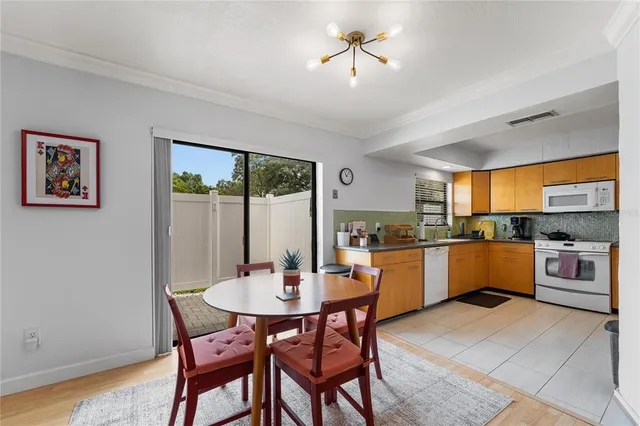 a kitchen with a table and chairs in it