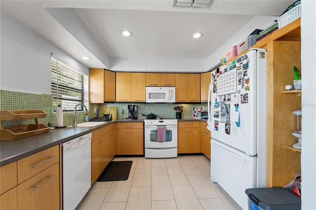 a kitchen with a refrigerator and a sink