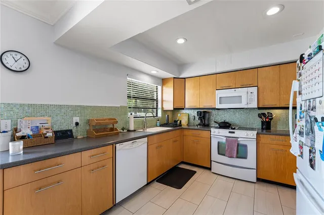 a kitchen with stainless steel appliances granite countertop a sink and cabinets