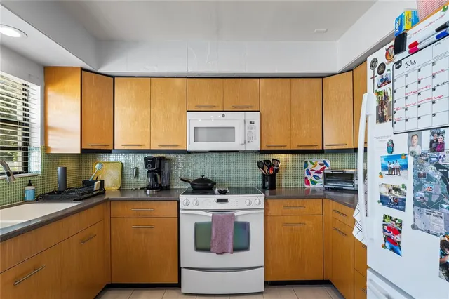 a kitchen with a sink cabinets and window