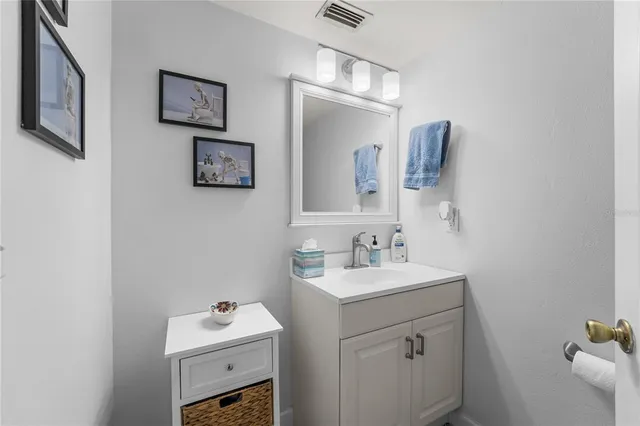 a bathroom with a sink mirror and toilet
