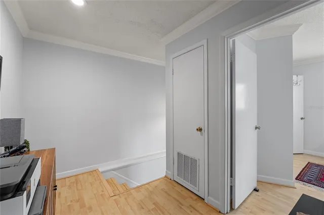 a view of a room with wooden floor and bedroom