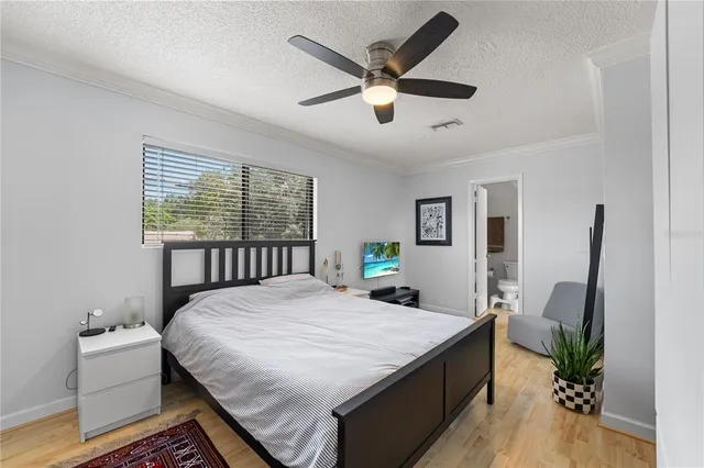 a bedroom with a large bed and a window