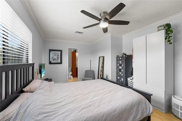 a bedroom with a large bed and a chandelier