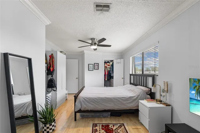 a bedroom with a large bed and a chandelier