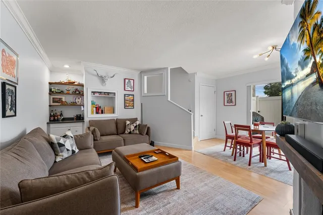 a living room with furniture a rug and a bookshelf