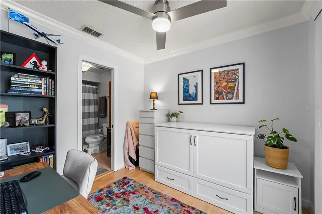 a bathroom with a granite countertop toilet sink and mirror