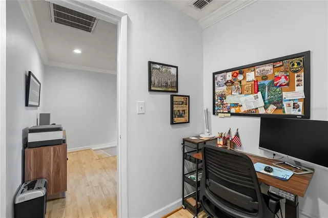 a workspace room with furniture and a flat screen tv