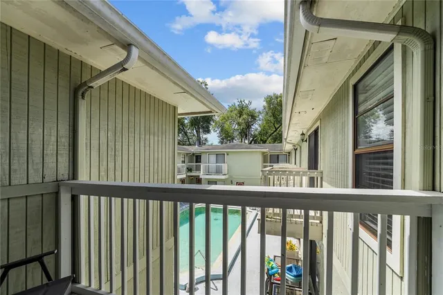 a swimming pool with outdoor seating
