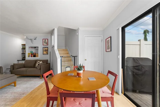 a view of a dining room with furniture and wooden floor
