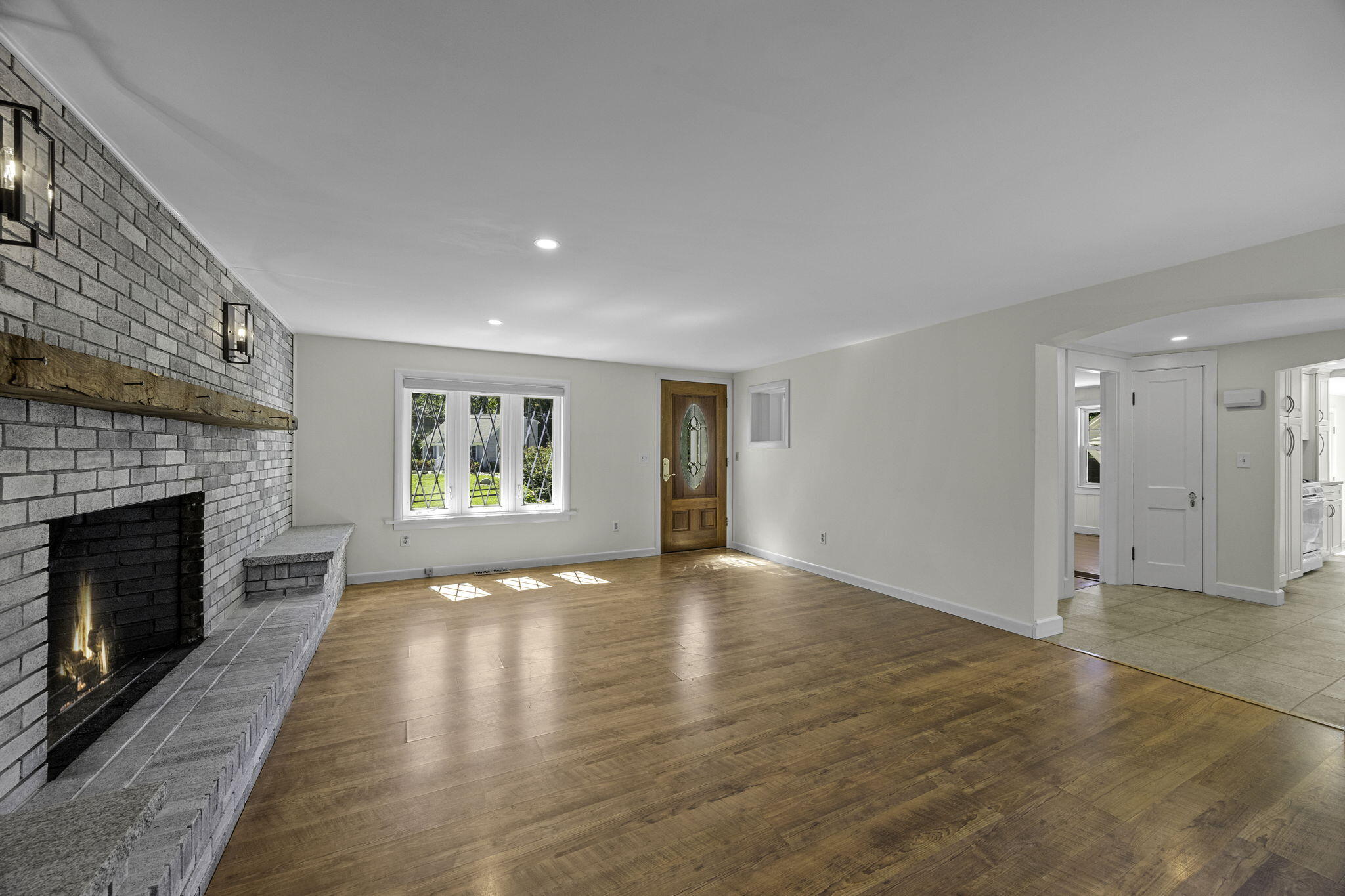 20 Namskaket Road Orleans, MA 02653 - Photo 11 of 63 a view of an empty room with wooden floor fireplace and a window