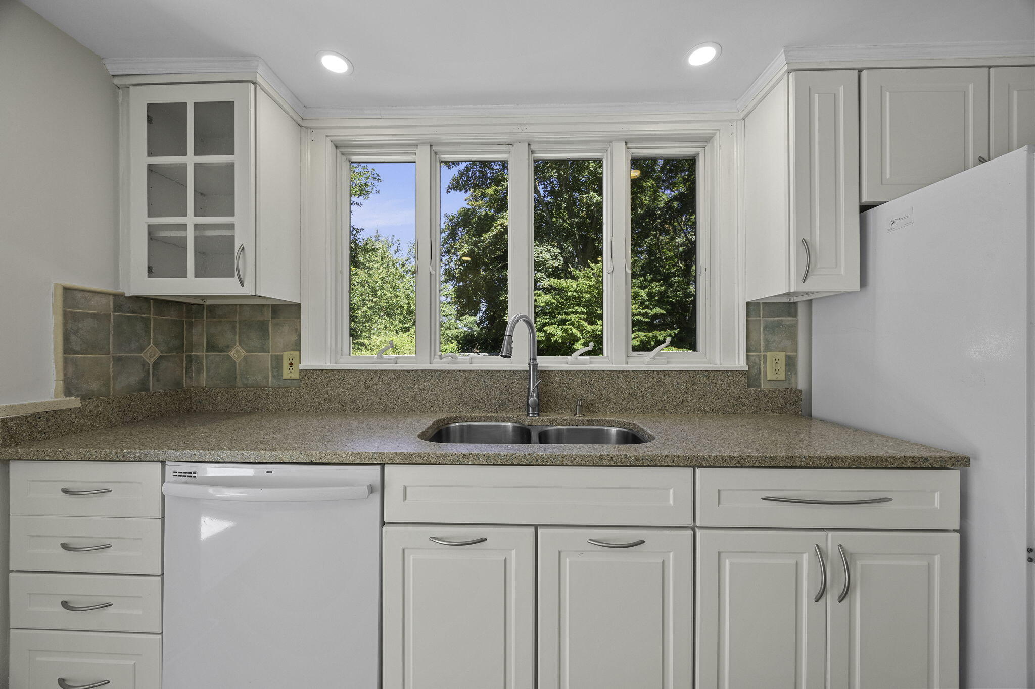 20 Namskaket Road Orleans, MA 02653 - Photo 18 of 63 a kitchen with granite countertop a sink and a window