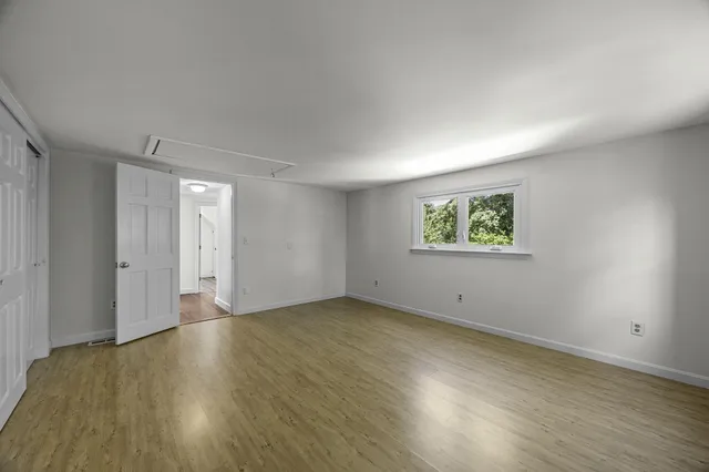 a backyard of a house with plants and a tree