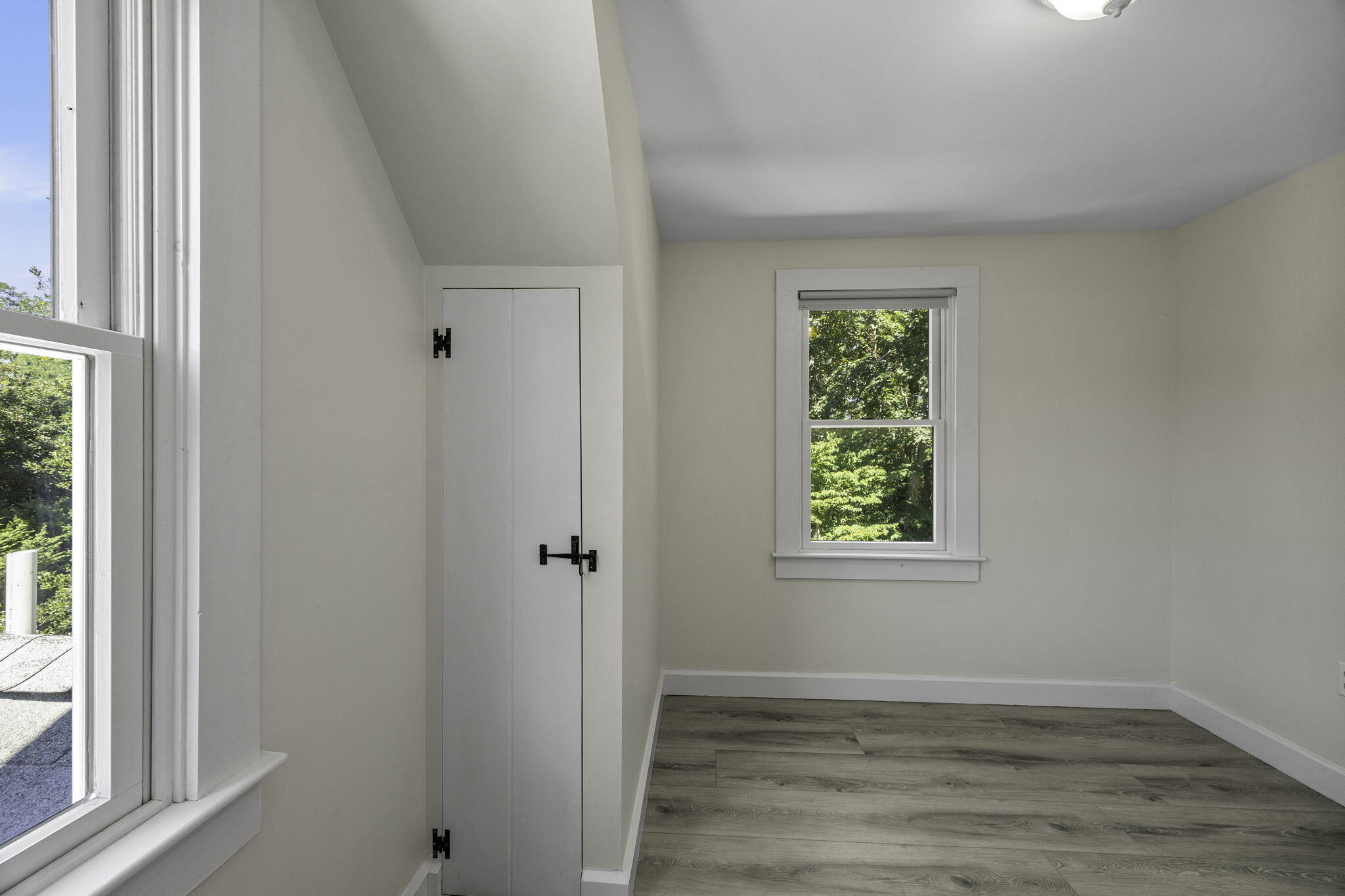 20 Namskaket Road Orleans, MA 02653 - Photo 29 of 63 an empty room with wooden floor and windows