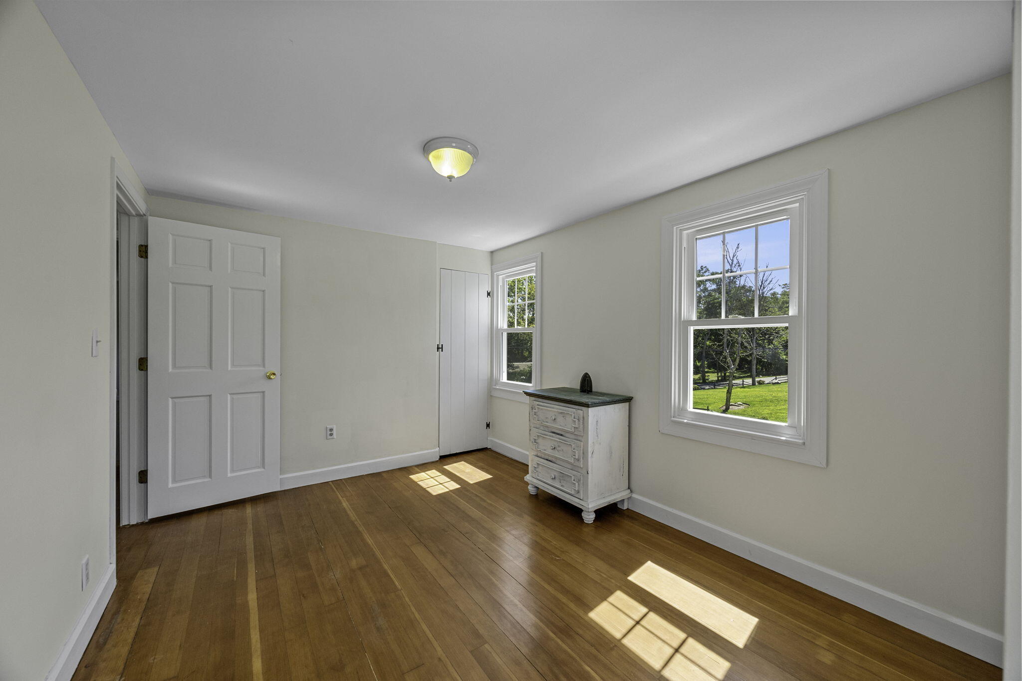 20 Namskaket Road Orleans, MA 02653 - Photo 33 of 63 an empty room with wooden floor and windows