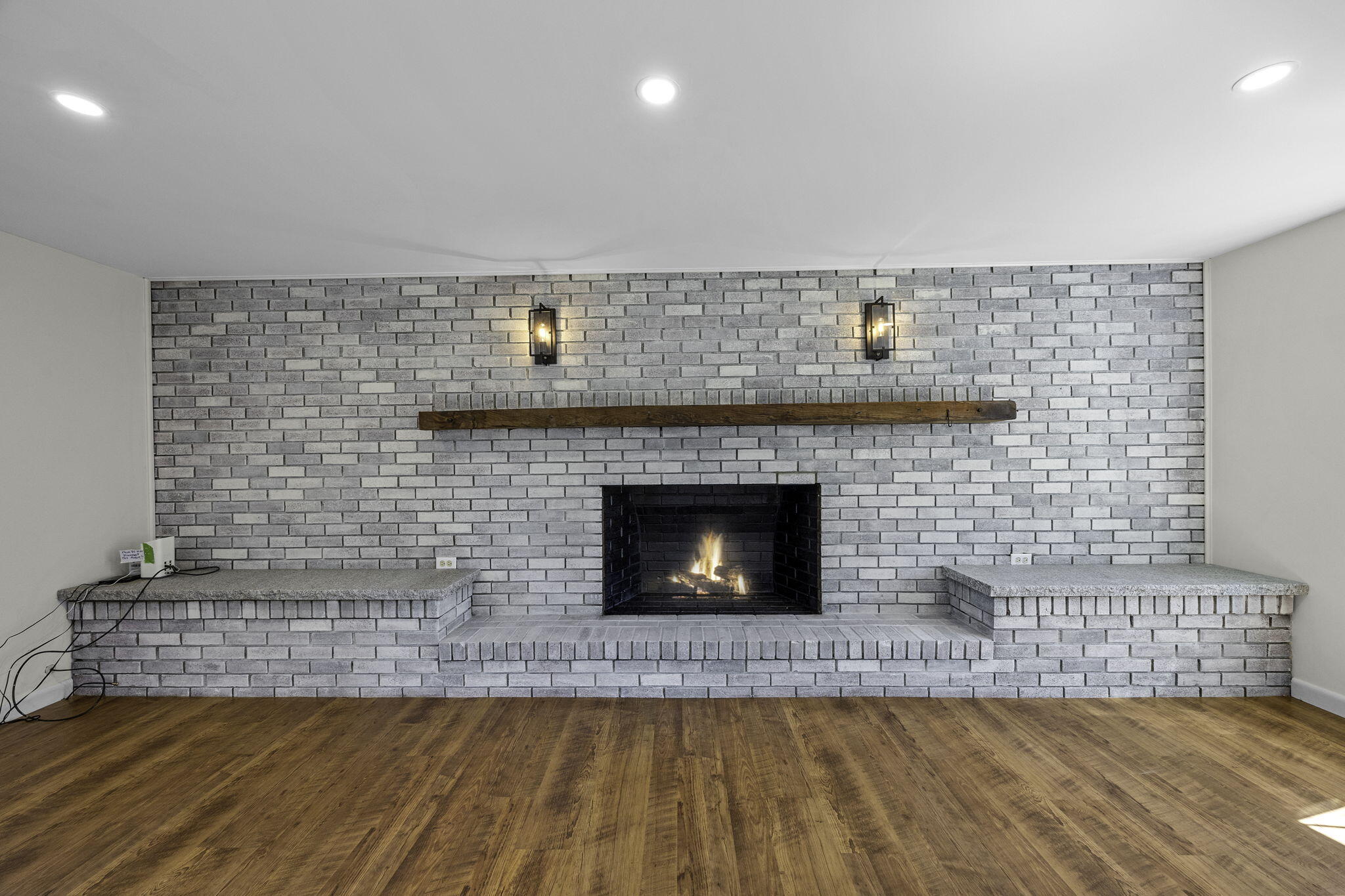 20 Namskaket Road Orleans, MA 02653 - Photo 8 of 63 a living room with a fireplace and a wooden floor