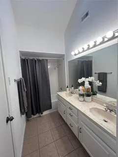 a bathroom with a double vanity sink and a mirror